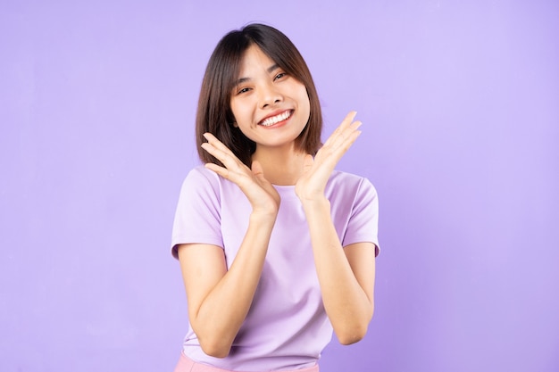 Beautiful asian woman portrait, isolated on purple background