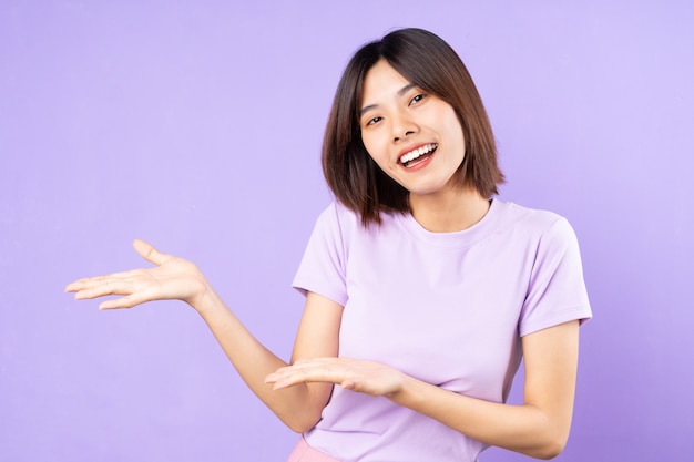 Beautiful asian woman portrait, isolated on purple background