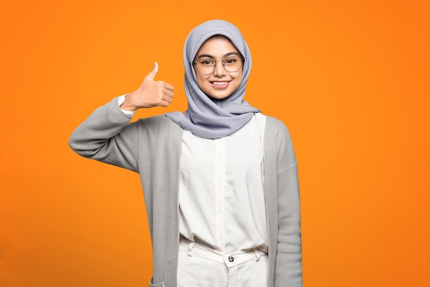 Beautiful Asian woman smiling and showing thumbs up