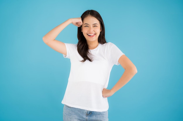 Beautiful Asian woman standing doing various poses on a blue background