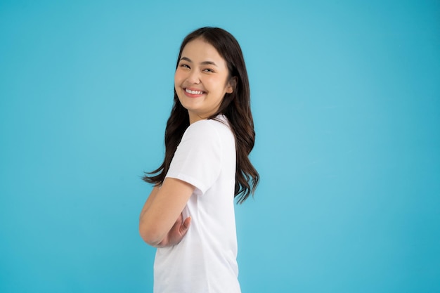 Beautiful Asian woman standing doing various poses on a blue background