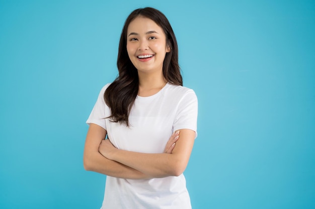 Beautiful Asian woman standing doing various poses on a blue background