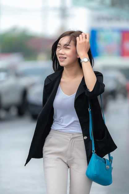 Beautiful asian woman walking for go to workYoung Successful Business woman in a big city