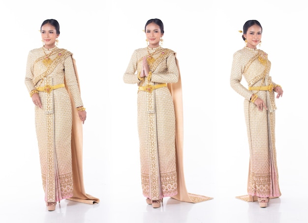 Beautiful Asian Woman wear Thai Traditional Costume as Thailand National Wedding Dress with gold decorative Fashion Items white isolated full length body