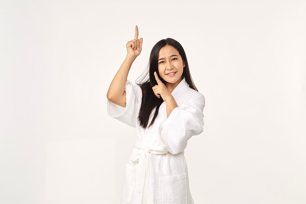 Beautiful Asian woman wearing bathrobe smile with clean and fresh skin