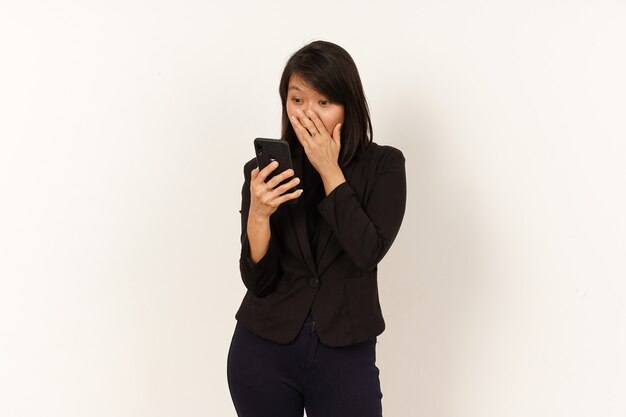 Beautiful Asian Woman Wearing black suit Surprised while using smartphone