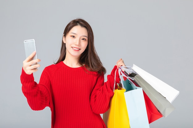 Beautiful Asian woman with shopping bags