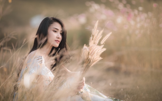 Beautiful asian women girl sitting posing in the park flower picture style vintage 