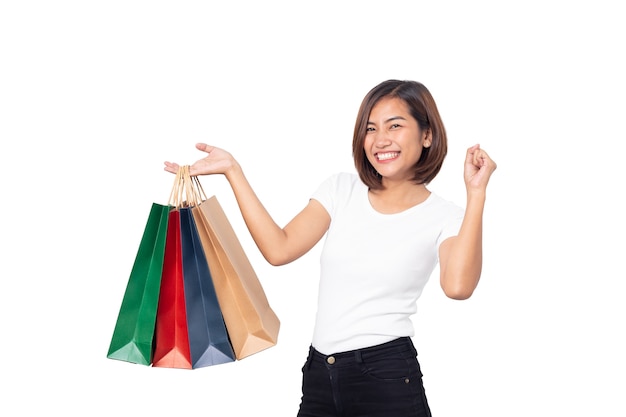 Beautiful Asian young woman smiling holding shopping bags isolated