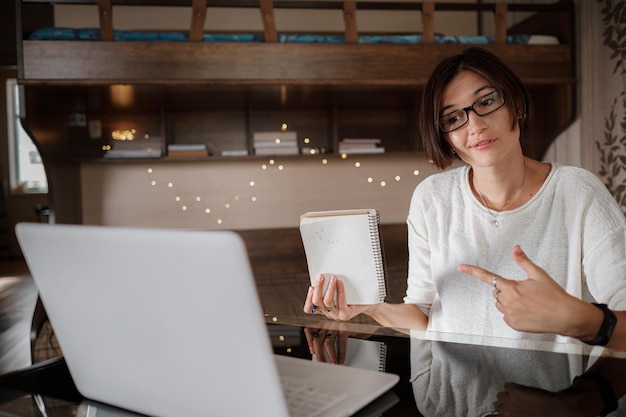 Beautiful asian young woman working on laptop computer while sitting at the living room