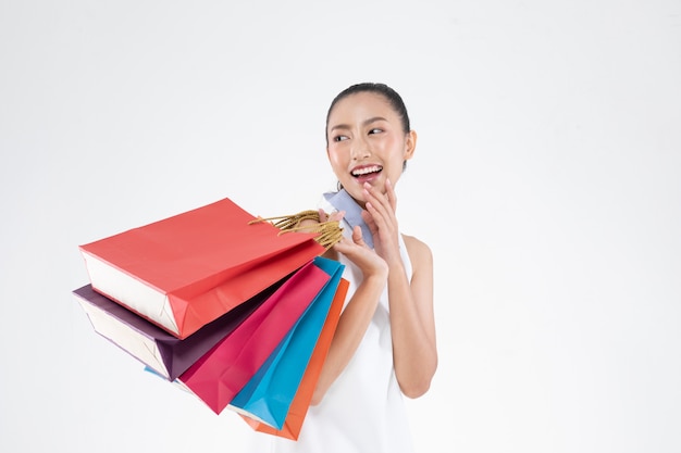 Beautiful Attractive Asian Woman smile and holding shopping bags feeling so happiness and enjoy