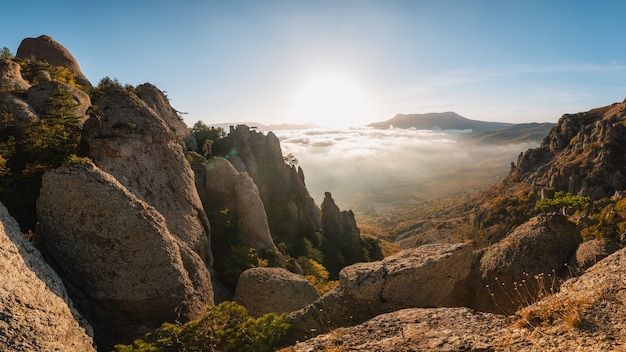 Beautiful autumn foggy landscape in the mountains, panoramic view. Crimea, Ghost valley, Mount Demerdzhi.