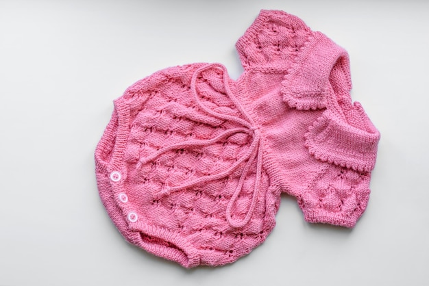 Beautiful baby knitted clothes and a toy for a newborn baby