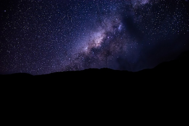 Beautiful background of night landscape with colorful Milky Way over the sky on the mountains.