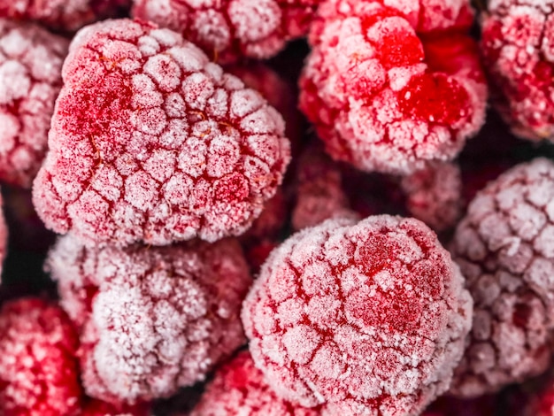 Beautiful background of red frozen raspberries