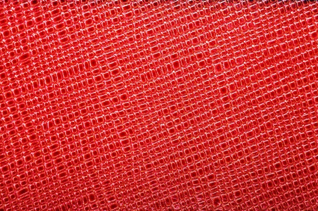 Beautiful background of red genuine leather. close-up. macros