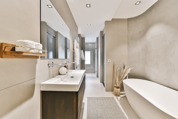 Beautiful bathroom with a big mirror and marable walls