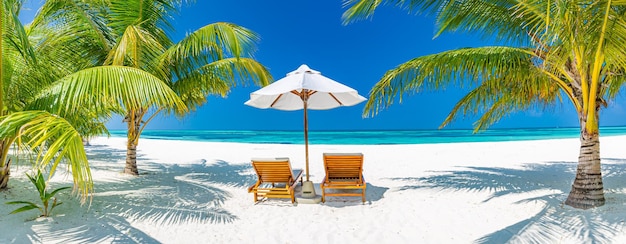 Beautiful beach. Couple chairs sandy beach near the sea. Summer holiday vacation concept, tourism