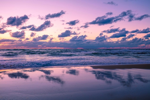 Beautiful beach in evening with reflection The time after sunset