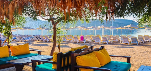 Beautiful beach on the shores of the calm blue bay of the Aegean Sea at sunset. Beach vacation and holiday destination concept. Bitez, Bodrum, Turkey