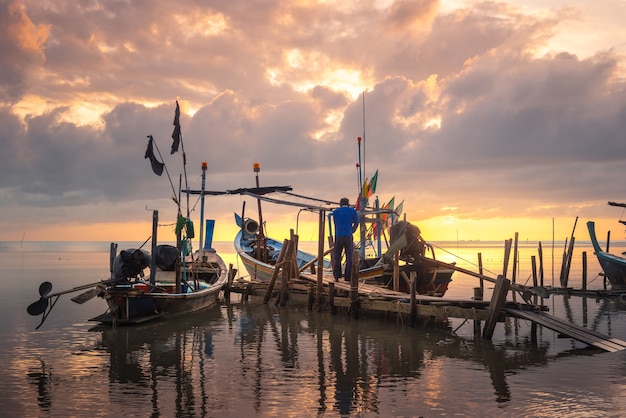 Beautiful beach with fisherman boat during sunrise on fisherman village