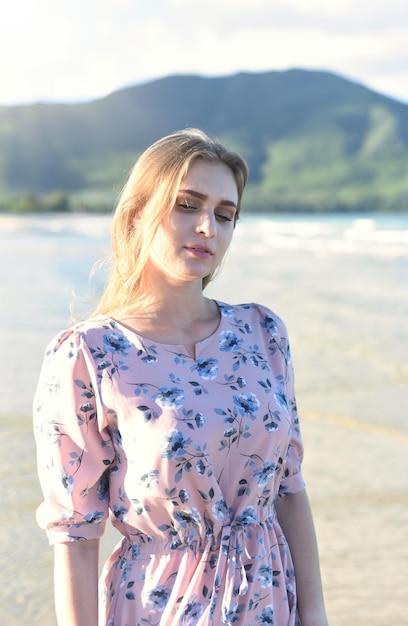 Beautiful Belarus woman walking on the beach against dramatic and romantic sky