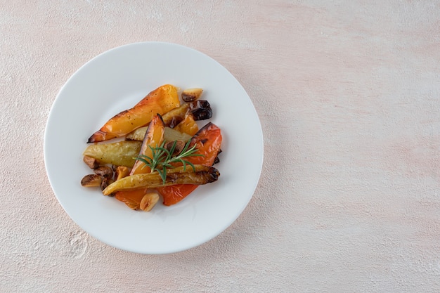 Beautiful bell peppers grilled on a white plate, close-up.