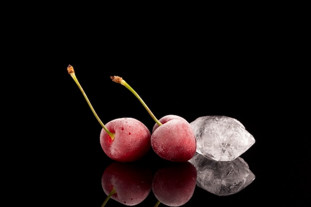 Beautiful berries covered with hoarfrost next to a piece of ice