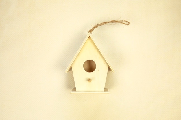 Beautiful bird house on beige background top view space for text spring concept wooden handmade