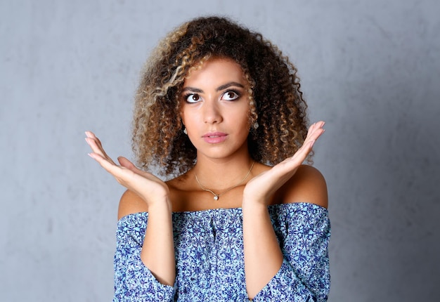 Beautiful black woman portrait hands up and