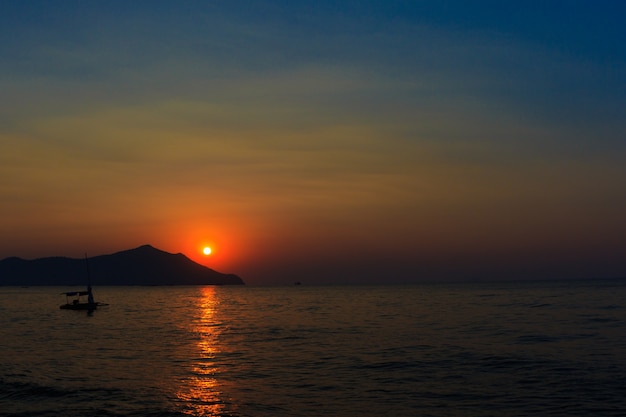 Beautiful blazing sunset landscape at black sea and orange sky above it 