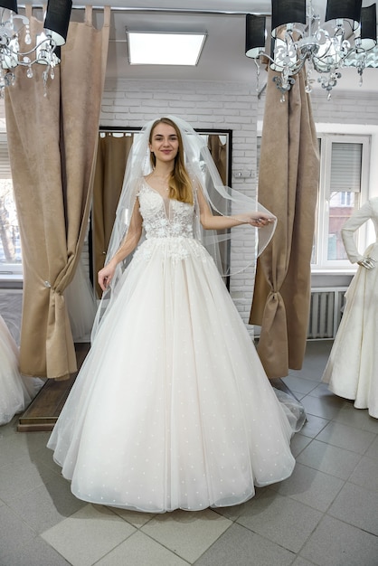 Beautiful blonde bride posing in wedding dress