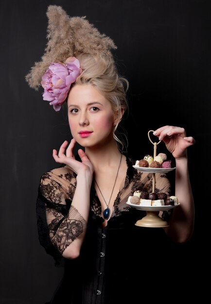 Beautiful blonde countess with chocolate candies