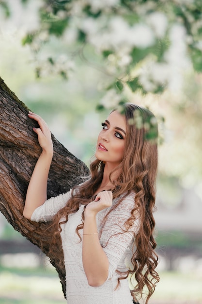 beautiful blonde girl walking in a spring Park