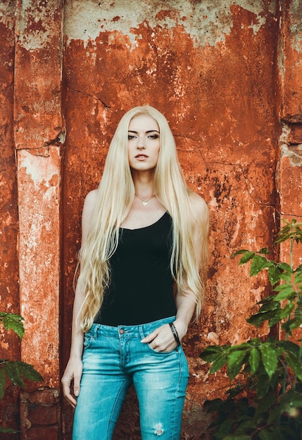 Beautiful blonde near the wall texture