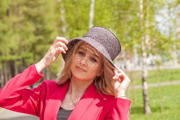 Beautiful blonde in a red jacket and hat City Style