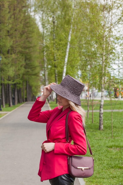 Beautiful blonde in a red jacket and hat City Style