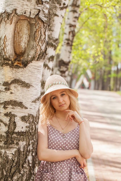 Beautiful blonde in a sundress and a hat