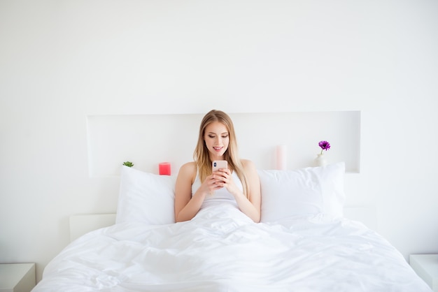 Beautiful blonde woman in her bed