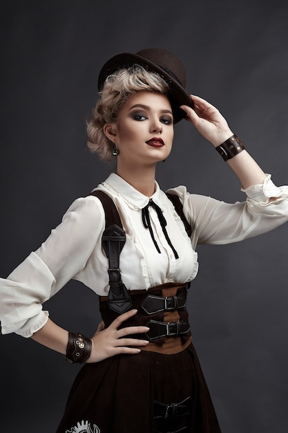 Beautiful blonde woman in steampunk style costume and earrings and necklace