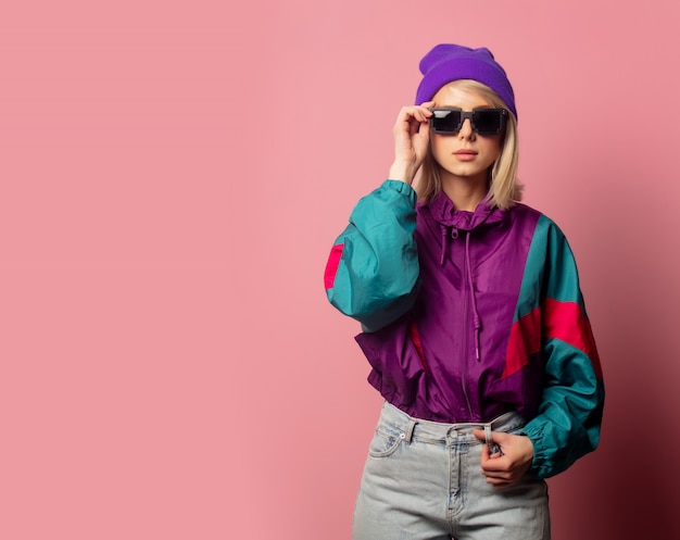 Beautiful blonde woman in sunglasses and 90s clothes