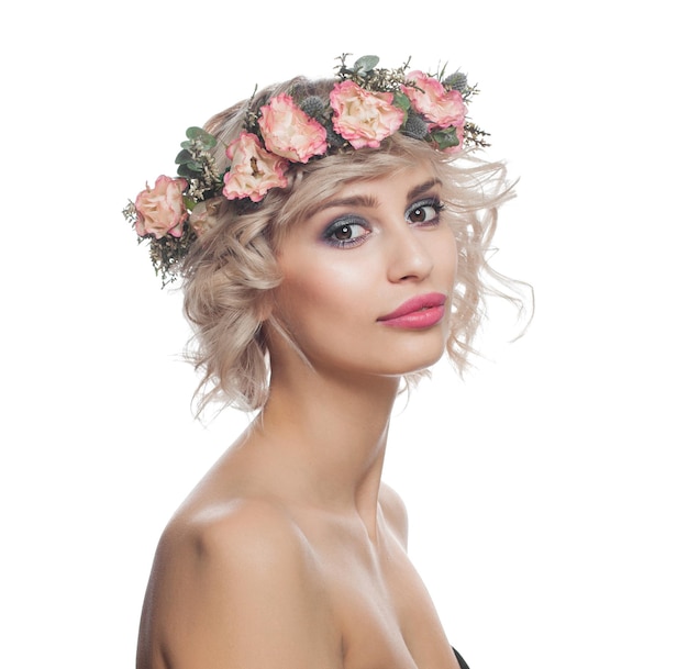 Beautiful blonde woman with short curly hair makeup and flowers crown isolated on white background