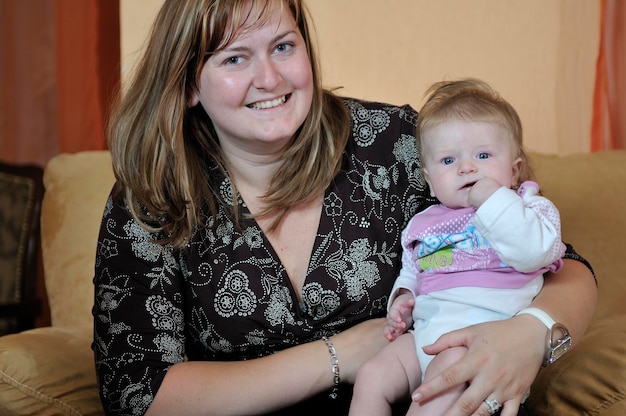 Beautiful blonde young mother and cute baby