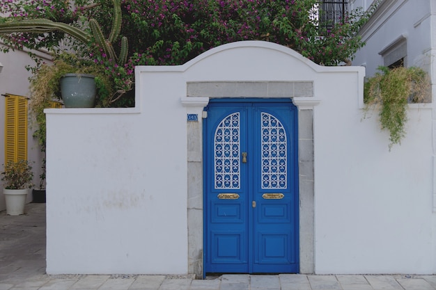 Beautiful blue door in a white wall in the style of european resorts bodurm turkey