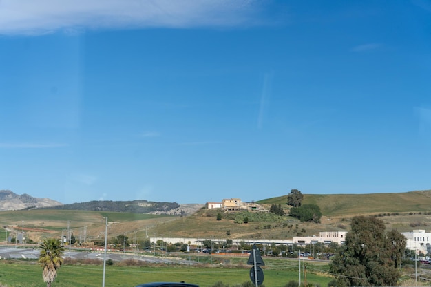 A beautiful blue sky with a few clouds and a small town in the background