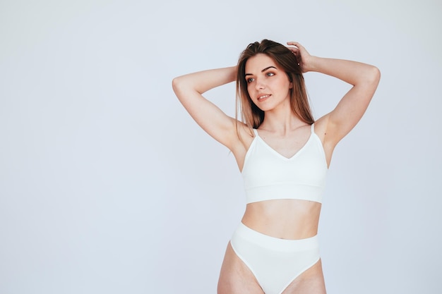 Beautiful Body of Woman in White Top and Shorts Hands raised behind head Healthy Body Skin Care