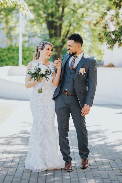 Beautiful Bosnian wedding couple having fun in the park