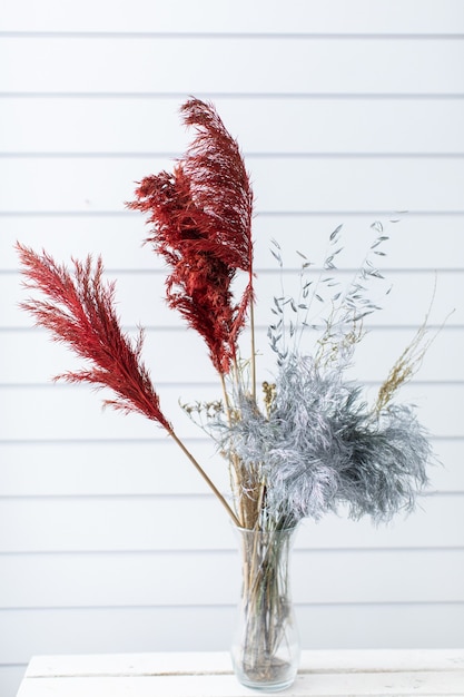 Beautiful bouquet of beautiful from dyed grass. The work of the florist. Flower delivery.