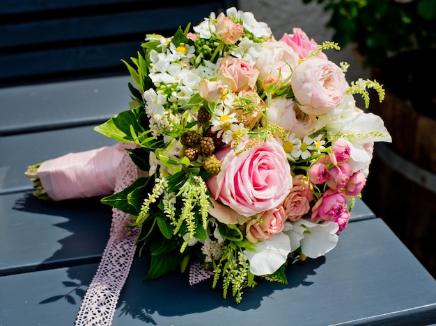 Beautiful bouquet of the bride on a wooden table.