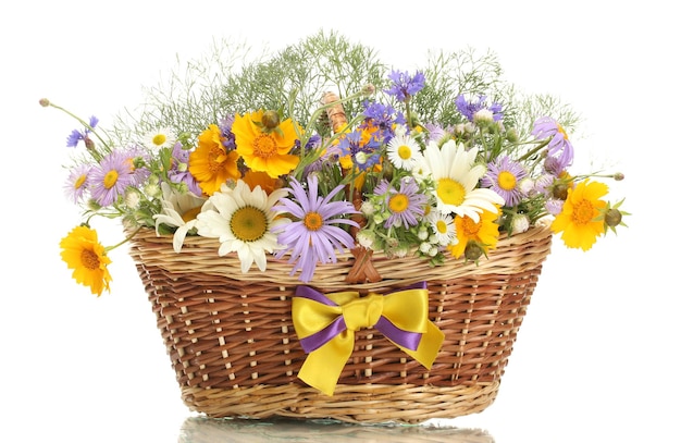 Beautiful bouquet of bright wildflowers in basket isolated on white